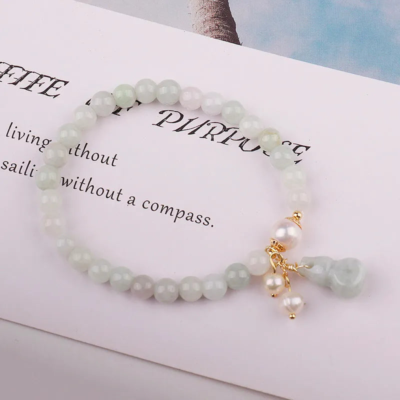 Emerald green jade bracelet with Chinese gourd design elements