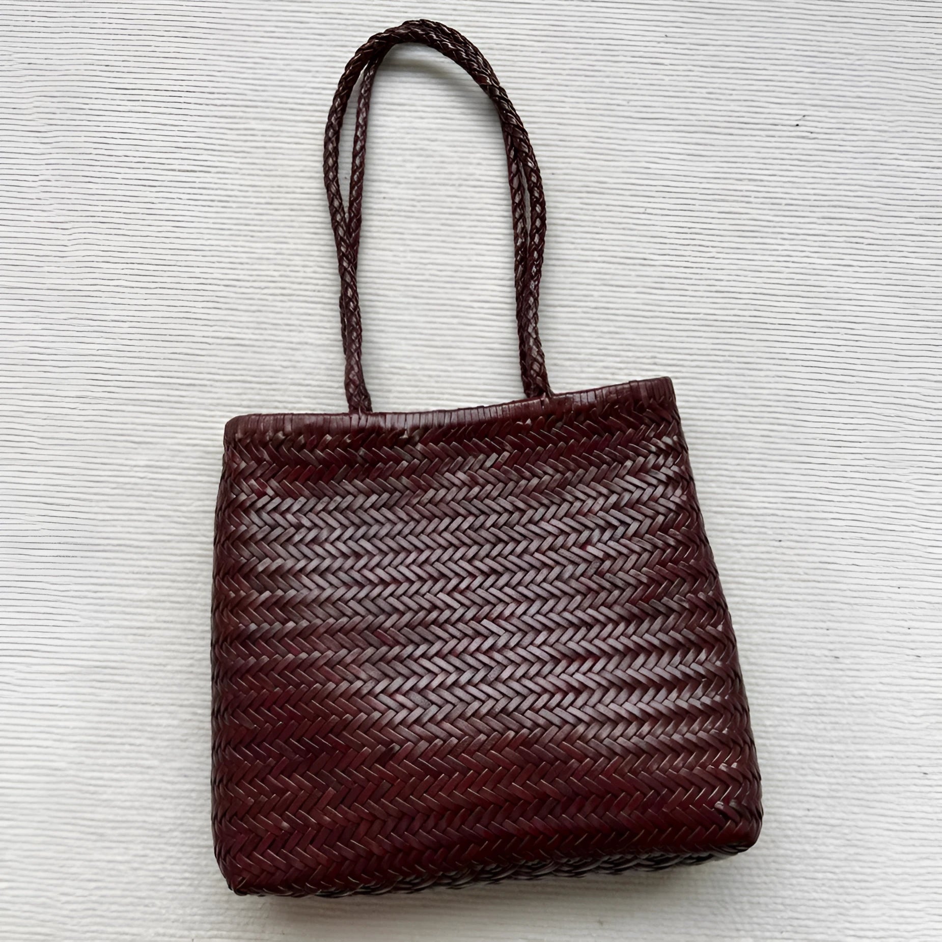 Brown woven leather tote bag with three-dimensional pocket and polyester lining
