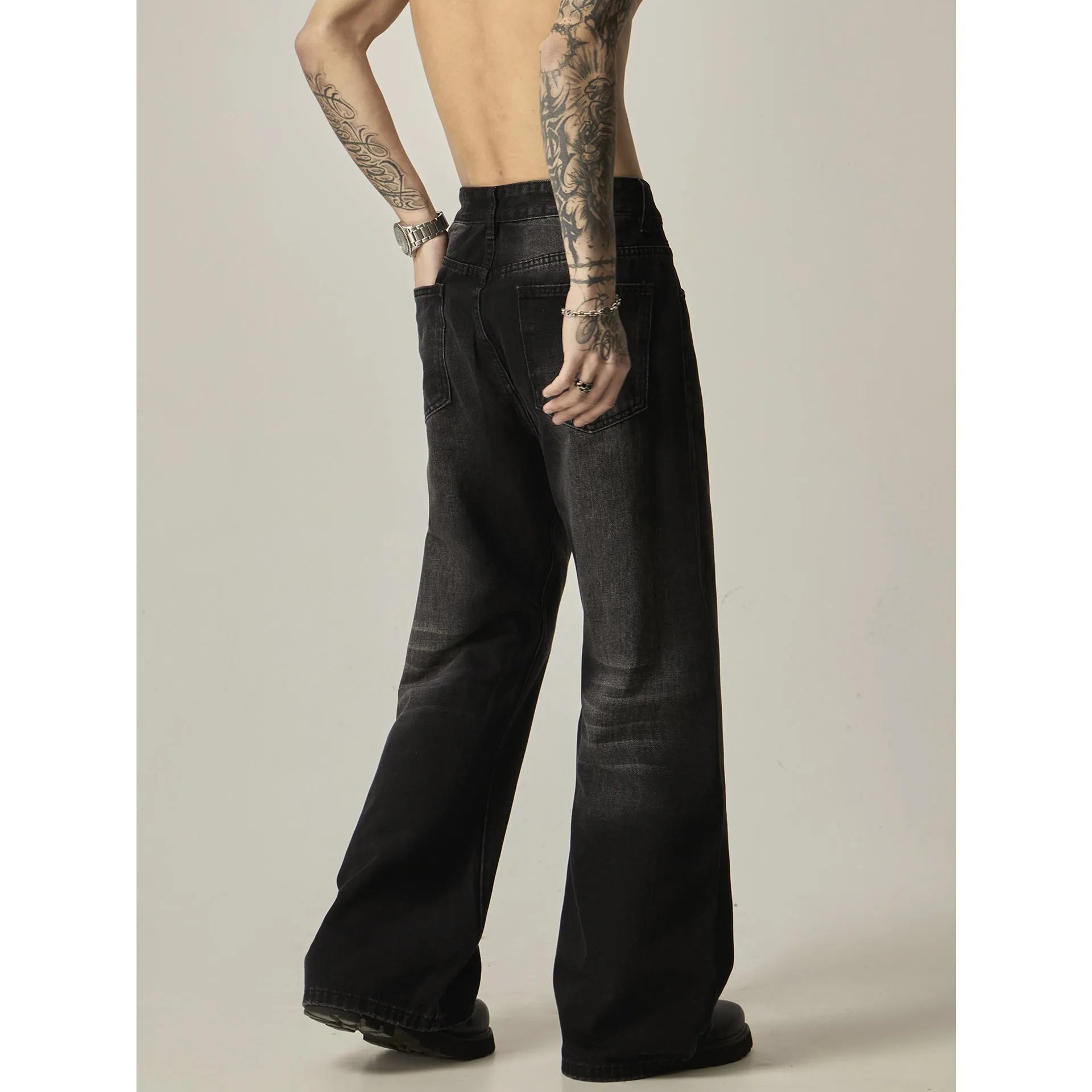 Black loose straight-leg jeans with retro styling and zipper fly