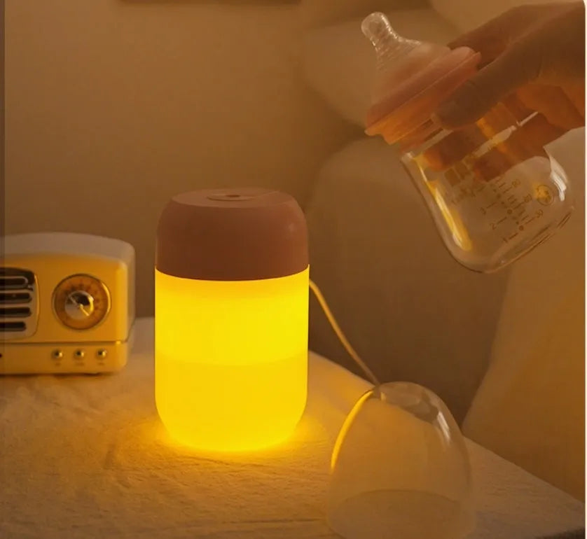 White cylindrical mini USB humidifier with aromatherapy function on wooden desk