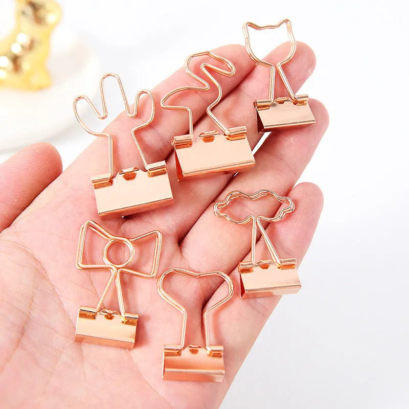 Gold metal decorative paper clip showing flamingo, love, cloud, cat, cactus, and bow shape options.