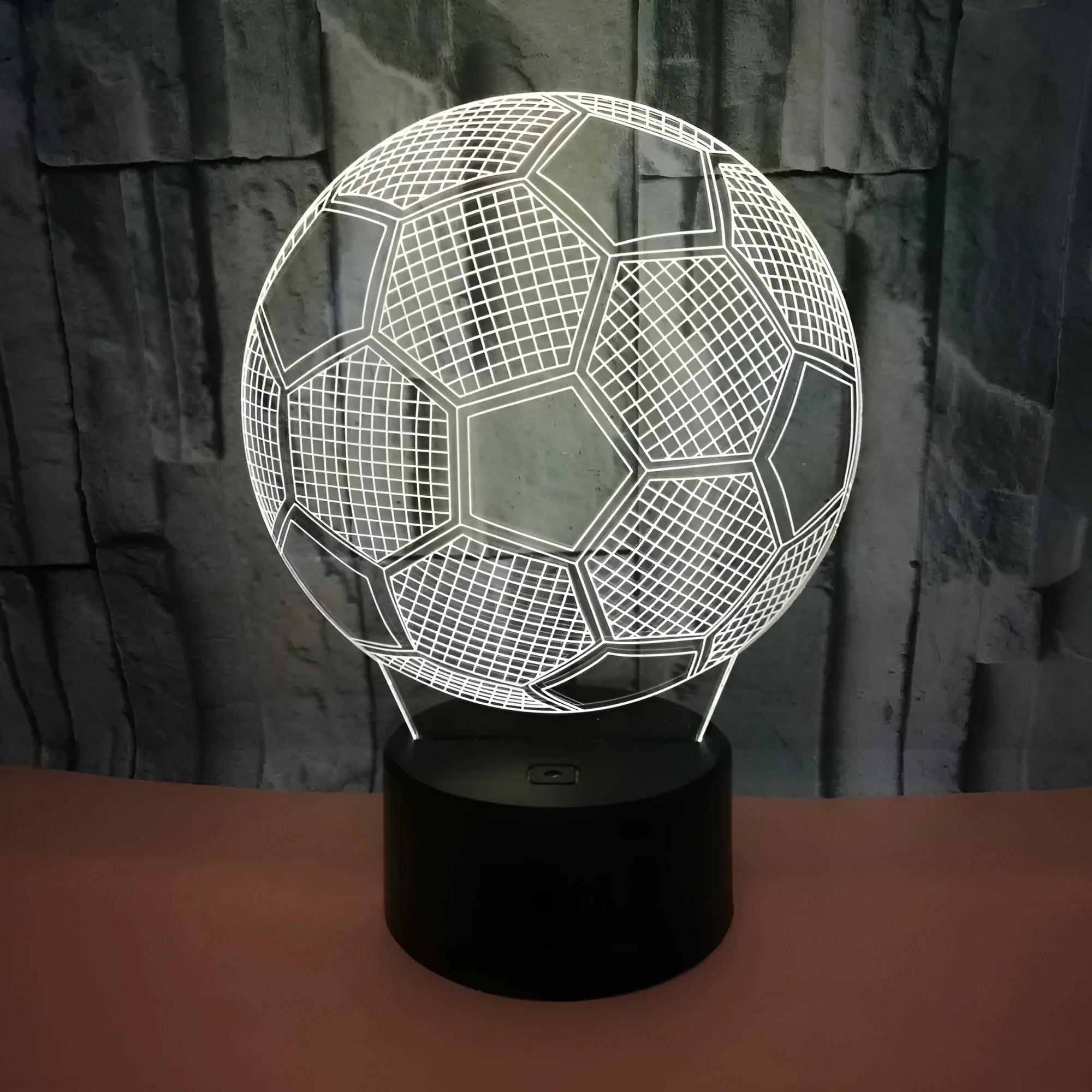 3D football shaped night light with colourful LED illumination on a black ABS base.
