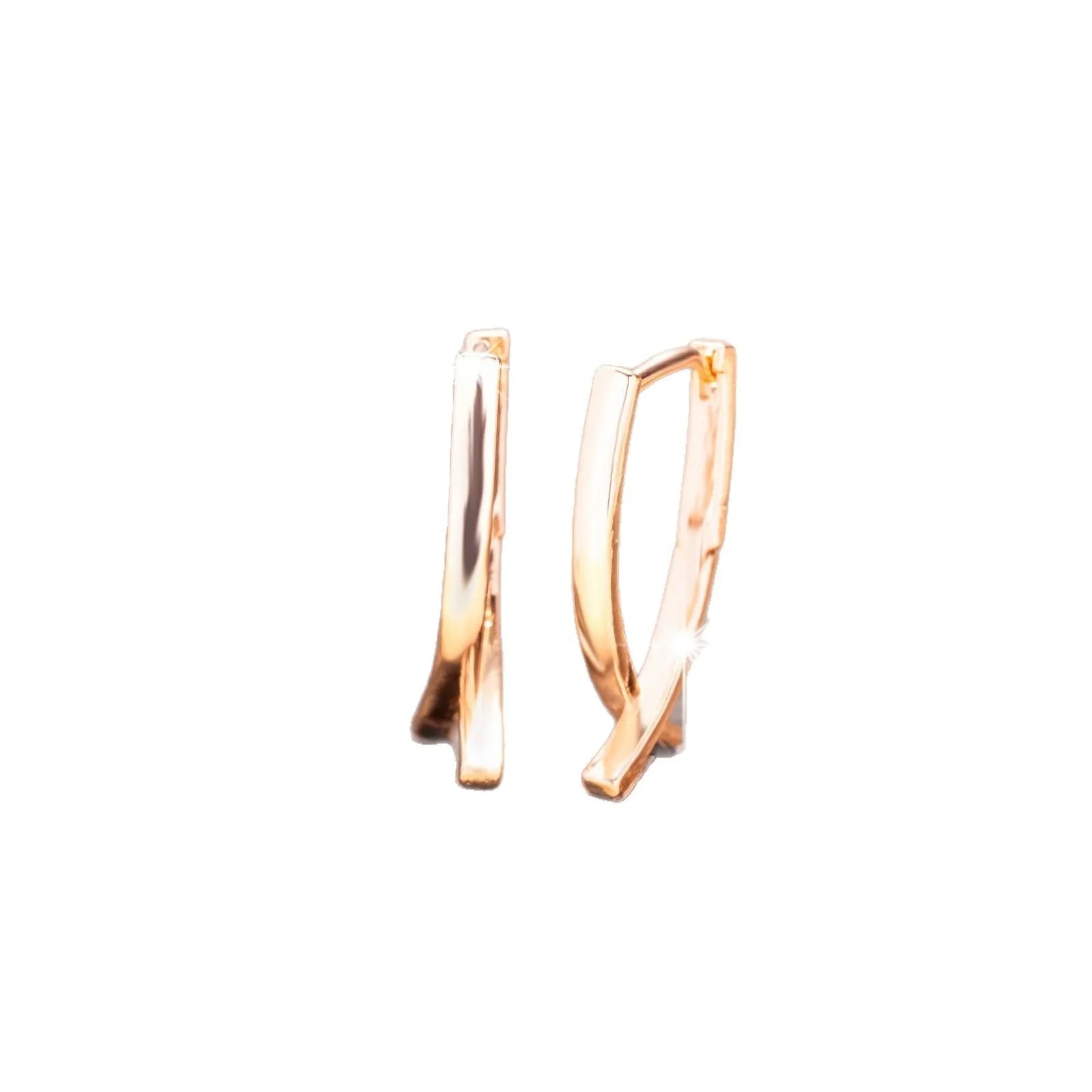 Rose gold cross shaped earrings with metallic finish and pendant design