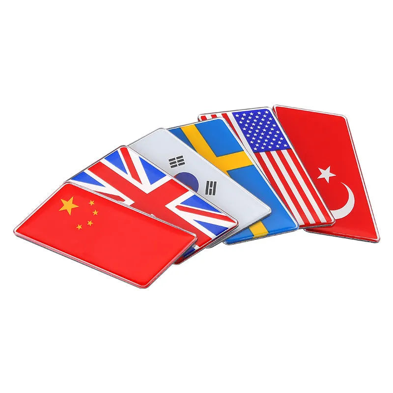 Aluminium national flag car sticker in parallelogram shape, 6.3cm by 3cm, on car rear bumper.