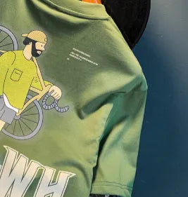 Green men's oversized t-shirt with a printed graphic design and short sleeves on a hanger