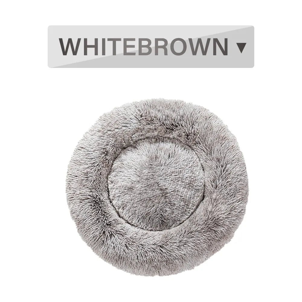 Fluffy grey donut dog bed with raised rim, shown with a small dog sleeping inside.