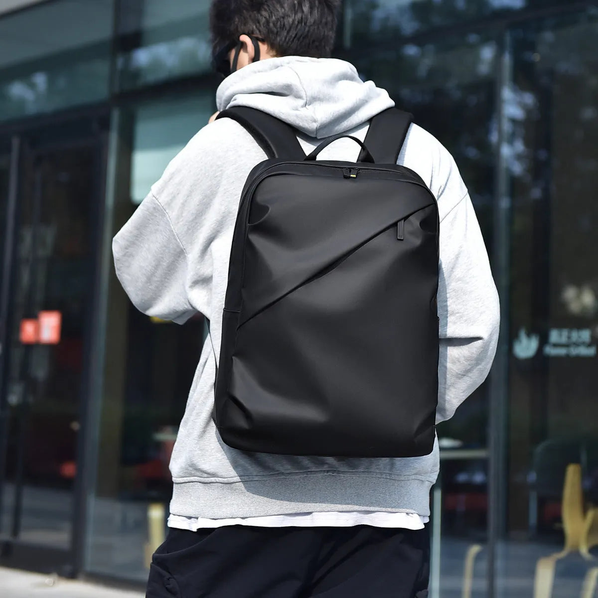 Waterproof PU leather backpack with sewing thread details in black, blue, and grey colour options