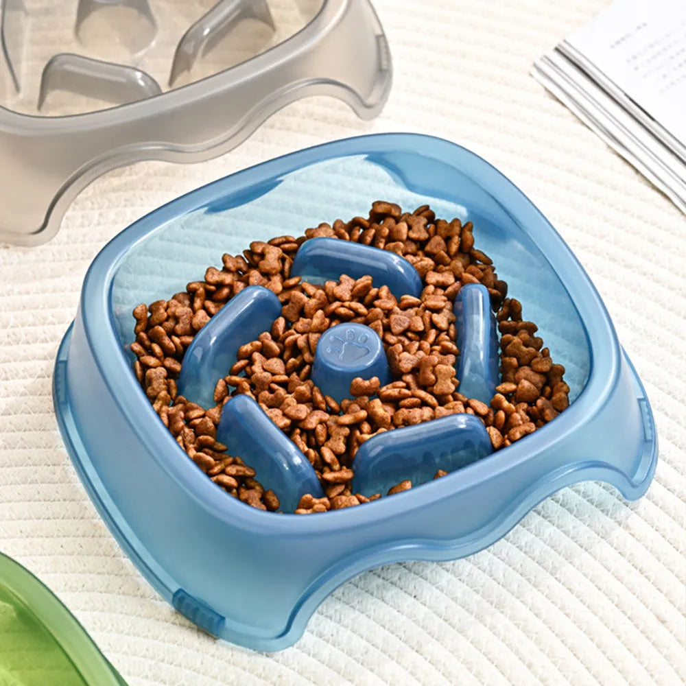 Blue plastic dog slow feeder bowl with anti-choking design on a white background.