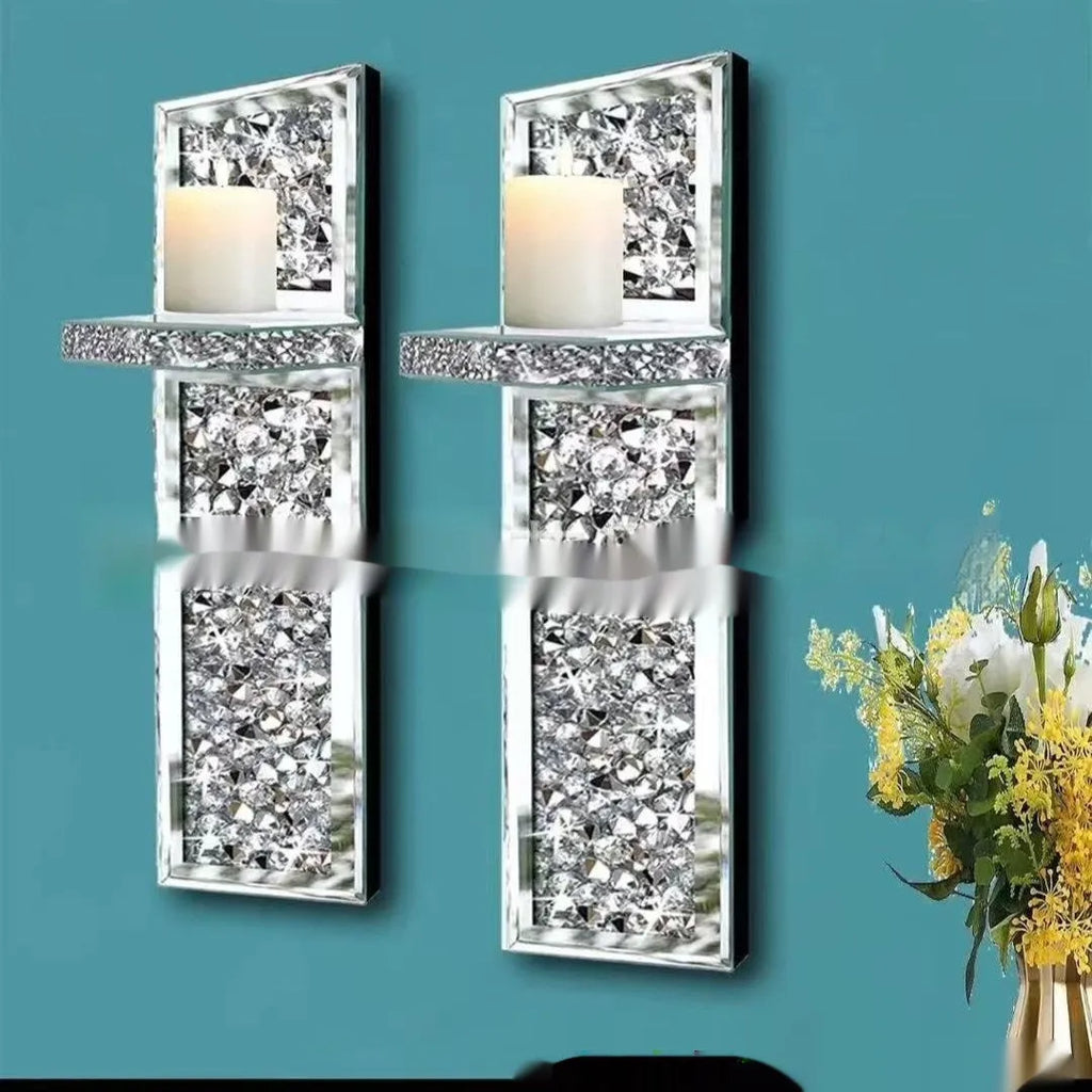 A pair of tall silver mirror glass candle holders designed for wall mounting