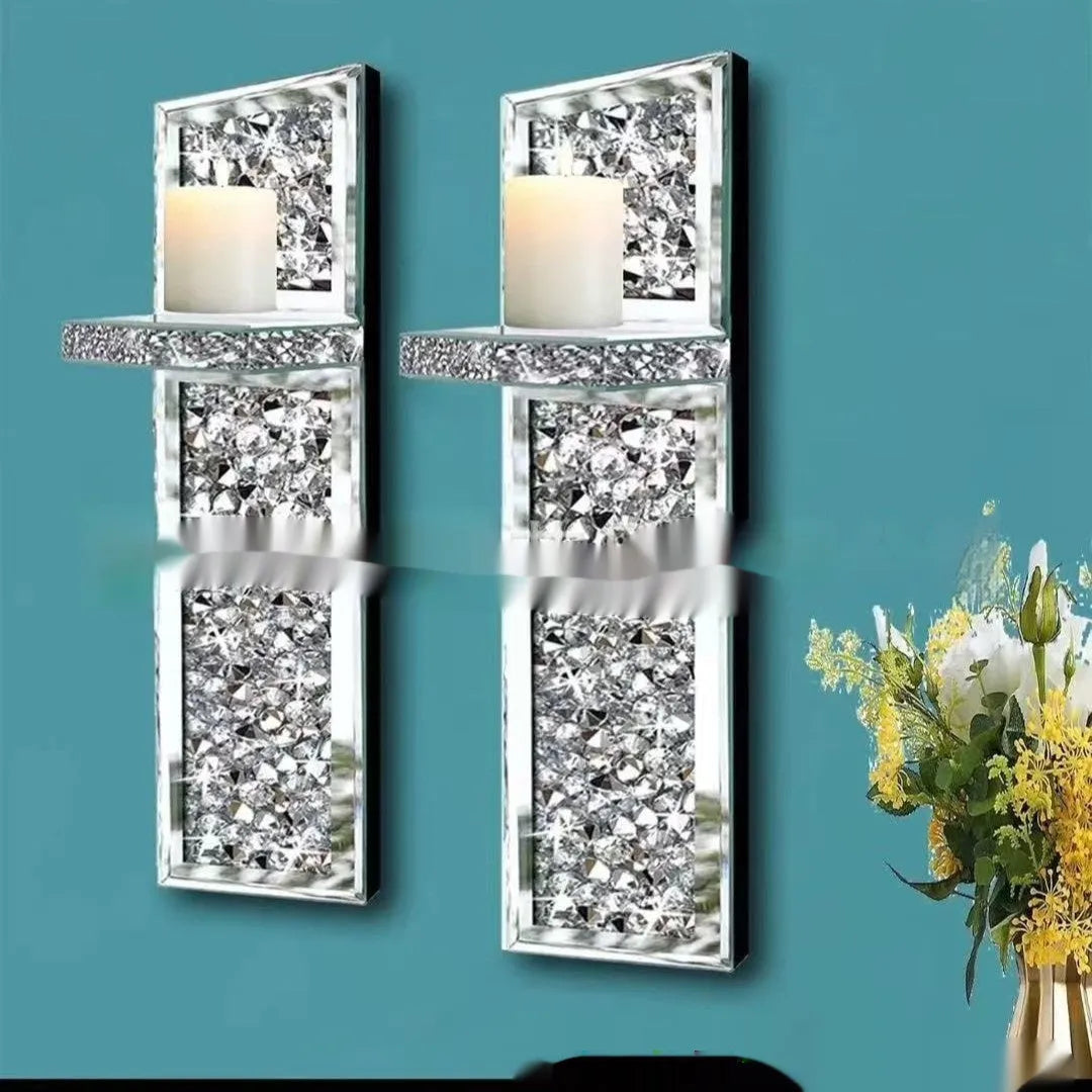 A pair of tall silver mirror glass candle holders designed for wall mounting