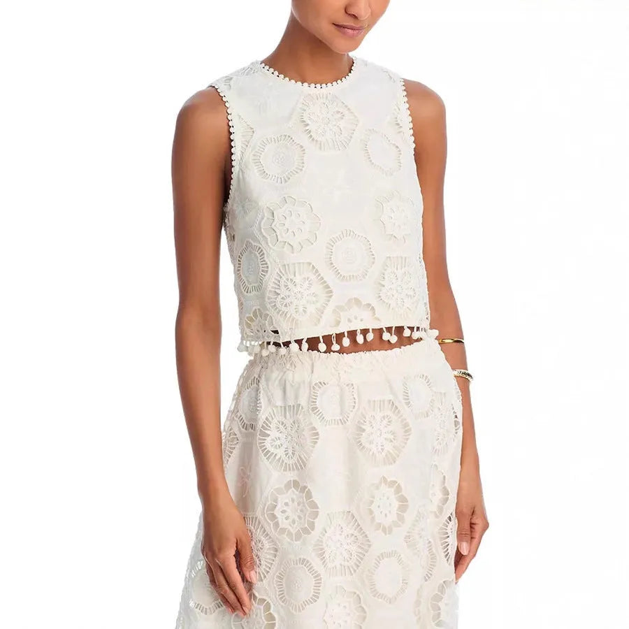 White women's sleeveless top and long skirt suit with embroidery detail