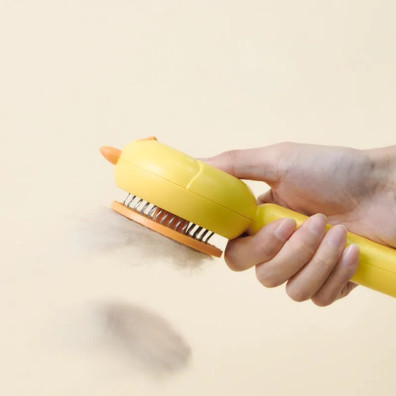 Purple pet grooming brush with stainless steel bristles and a self-cleaning button on a white background.
