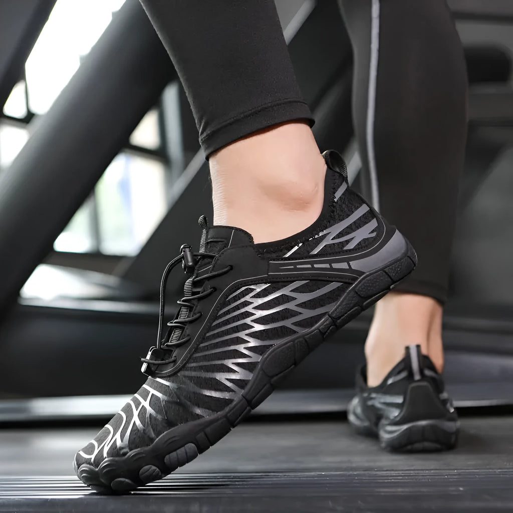 White and black lace-up casual trainers with rubber soles on a plain background