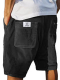 Men's grey corduroy shorts with multiple pockets and an elasticated waistband, shown in a straight leg fit.