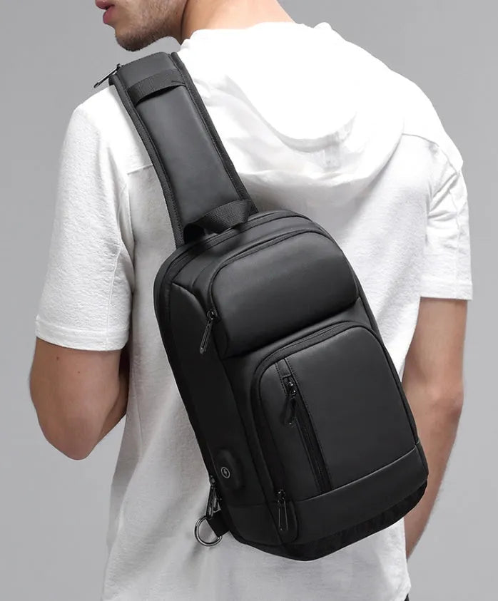 Black PVC outdoor shoulder bag with air cushion strap showing internal laptop and phone compartments