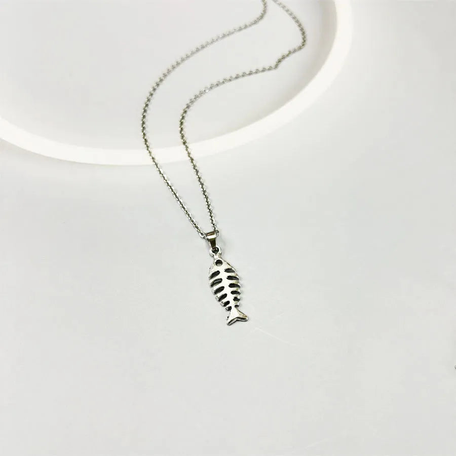 Silver-colour fishbone pendant necklace with O-chain and matching earrings on grey background
