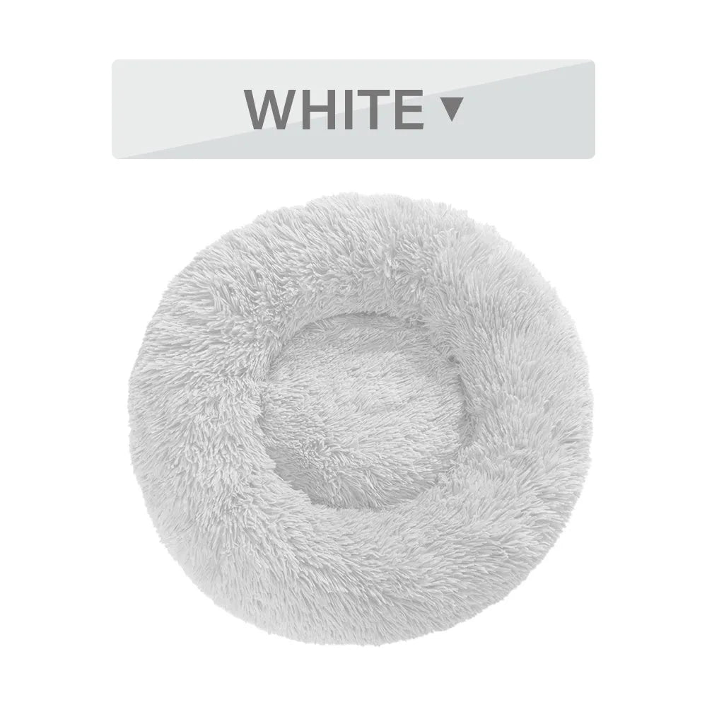 Fluffy grey donut dog bed with raised rim, shown with a small dog sleeping inside.