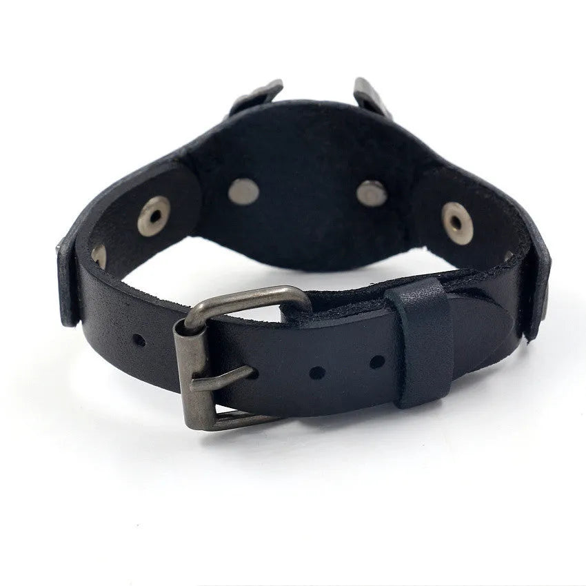 Black geometric leather bracelet with Eagle watch-button detail, showing tapered width.