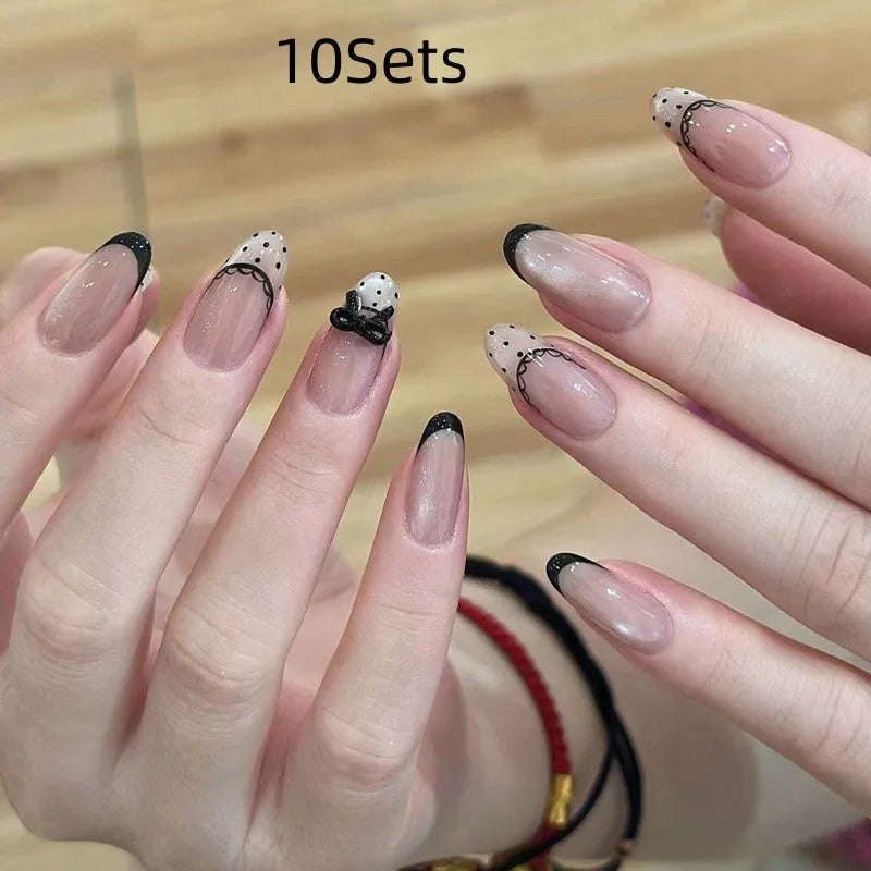 Set of sweet girl theme fake nails with colourful glitter and crystal decorations on a soft gel base.