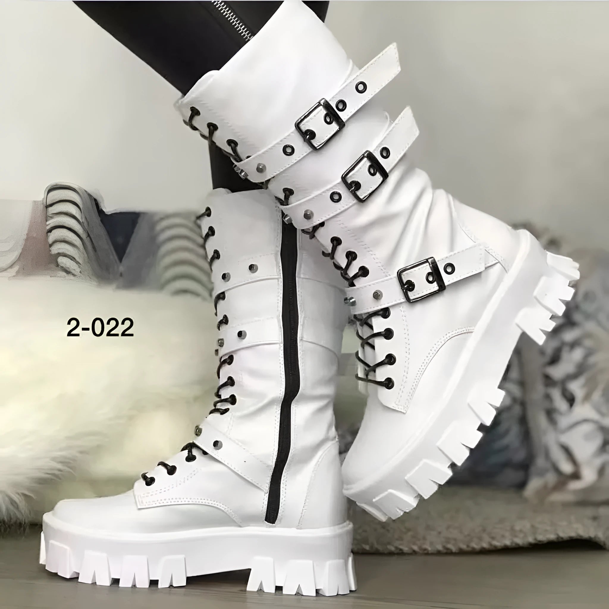 Women's black mid-calf boots with side zip and metal buckle detail on a white background.