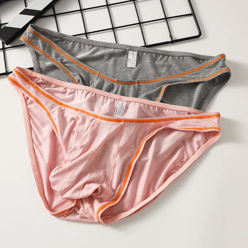 Men's dark grey modal hip-lift underwear laid flat, showing knitted ice silk fabric texture.