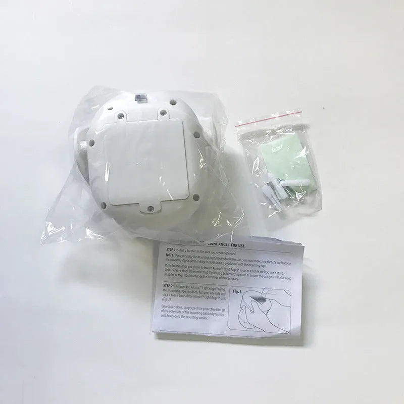White Atomic Angel induction night light with compact rectangular design and touchless activation sensor