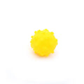 Bright coloured spiked squeaky balls for small dogs on grass