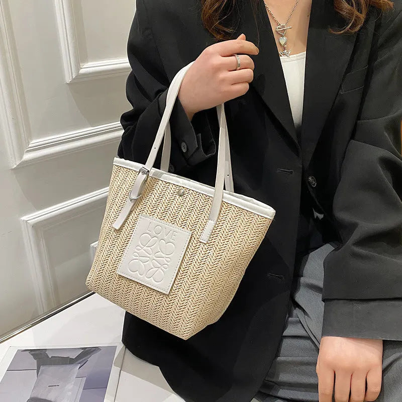Straw woven women's shoulder bag with 27cm width showing three-dimensional pocket and 18cm handle