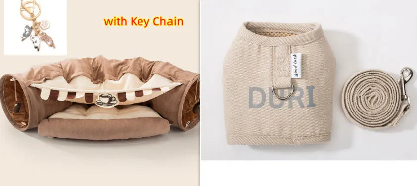 Collapsible cloth cat tunnel folded flat next to a cat, showing Coffee colour option.