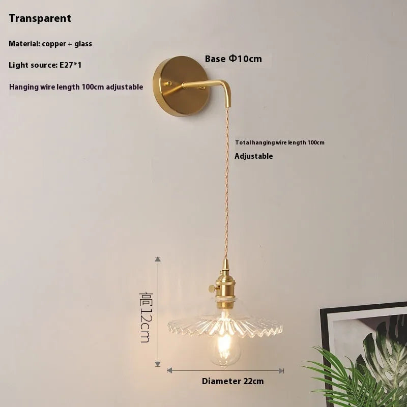 Retro brass wall lamp with lotus-shaped glass shade in choice of colours, mounted on a wall.