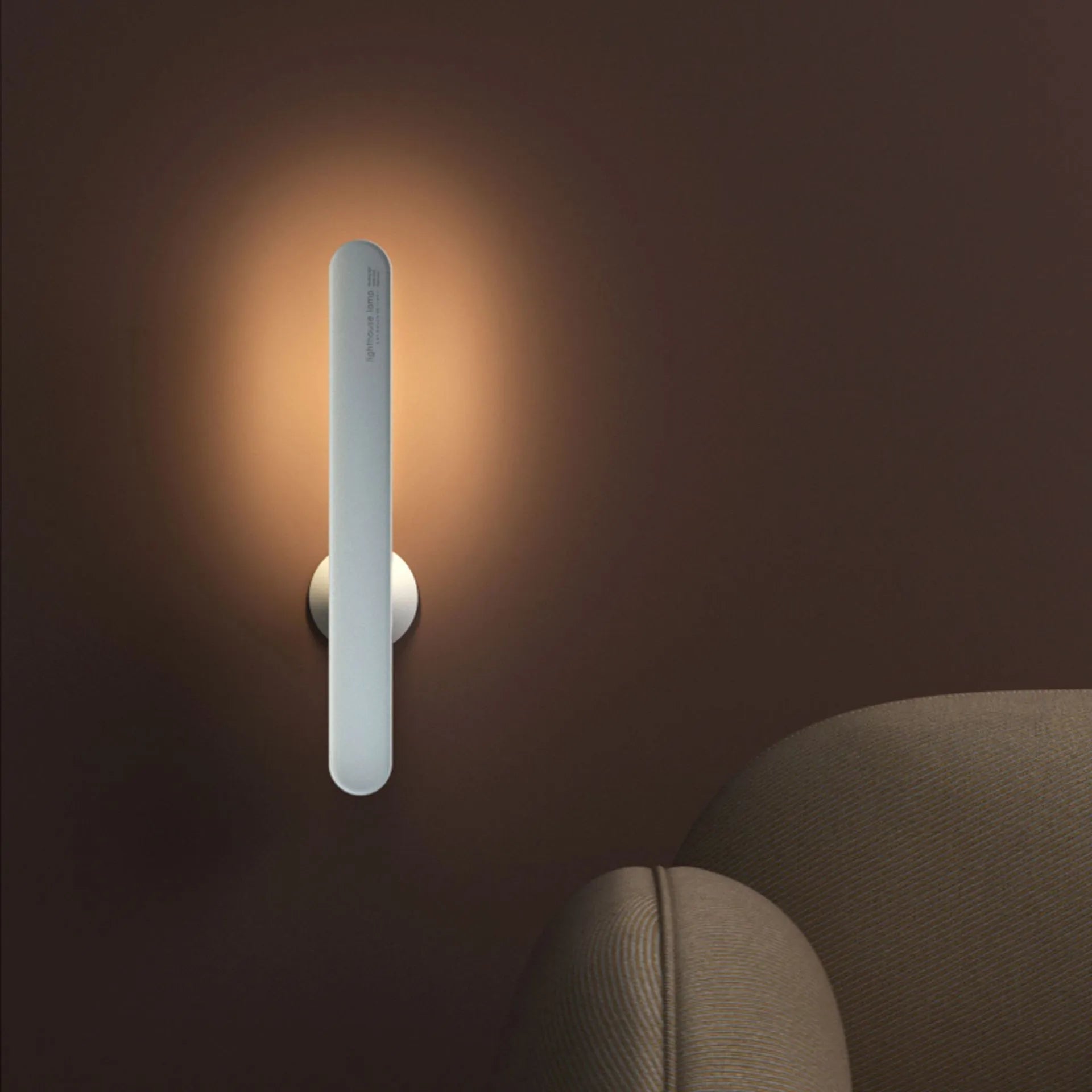 White geometric desk lamp with USB cable and magnetic base for wall mounting.