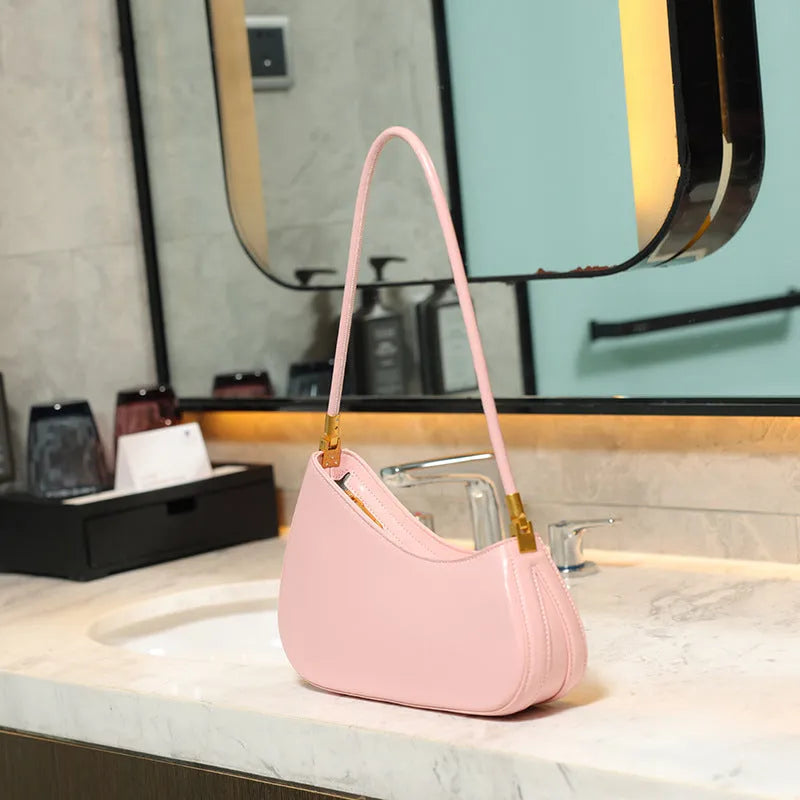 Structured oval women's underarm bag in PU leather with a single strap, shown in a colour option.