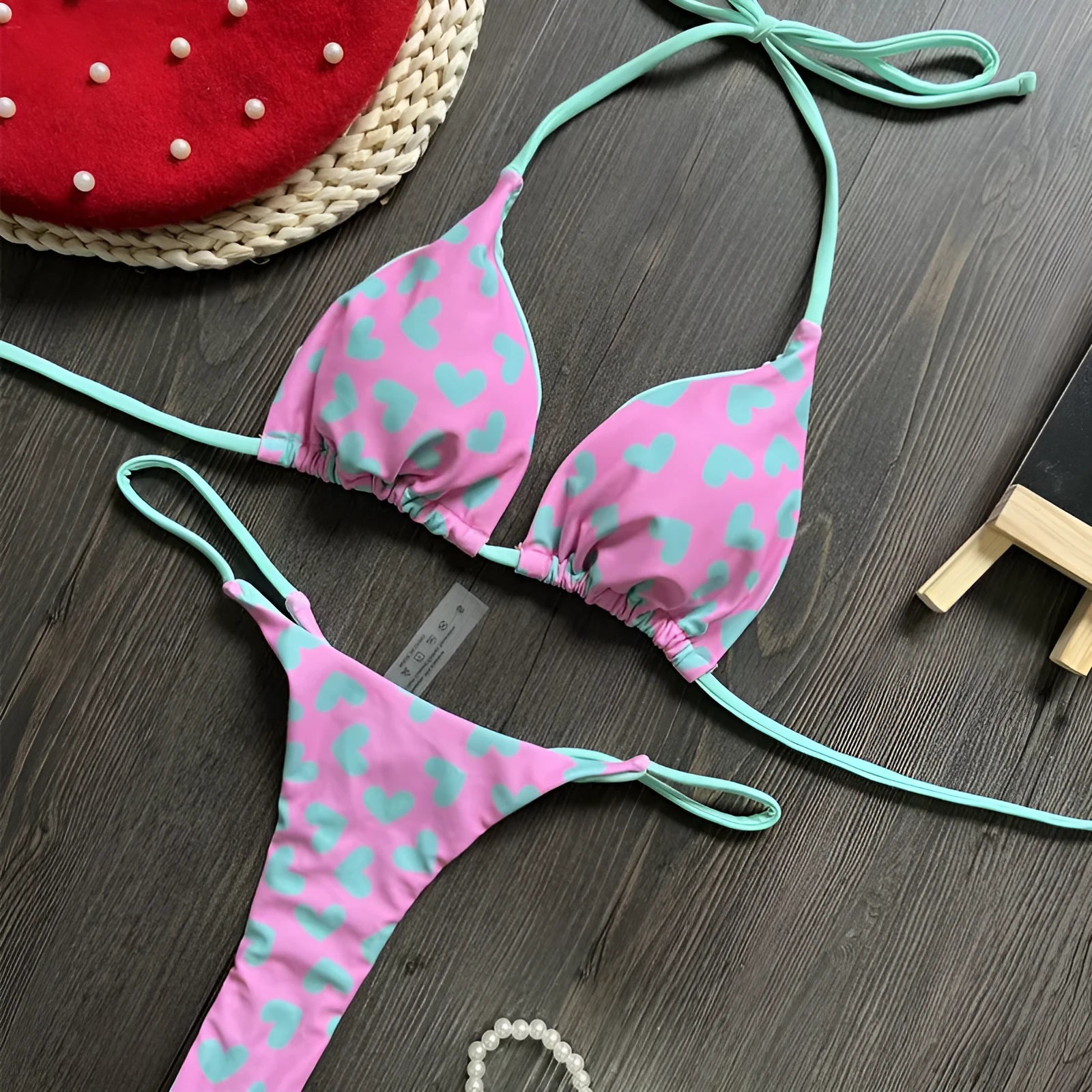 Backless one-piece swimsuit with heart print and split design in quick-dry nylon fabric.