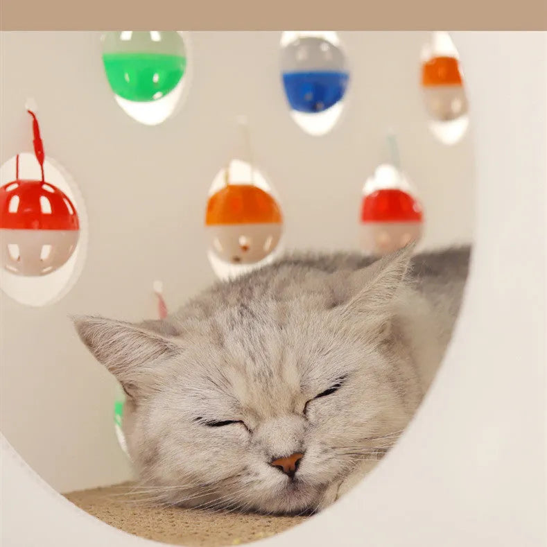 Plastic house cat scratch board with integrated tunnel containing a bell ball toy