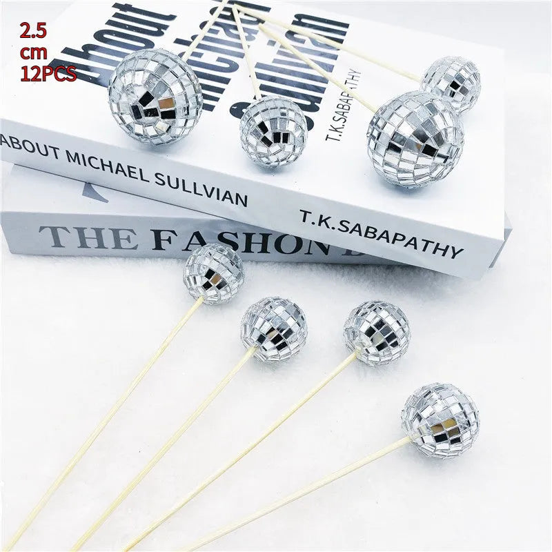 Glass mirror disco ball cake topper on a wooden stick for birthday party cupcakes.