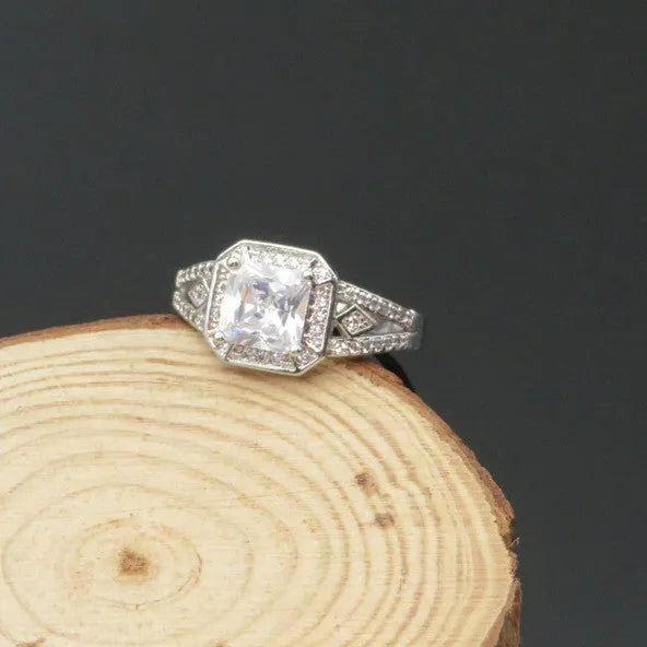 Platinum colour geometric zircon ring with hollow quadrilateral design on finger