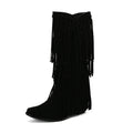 Women's brown suede knee-high boots with tassels, a chunky heel, and a waterproof platform sole.