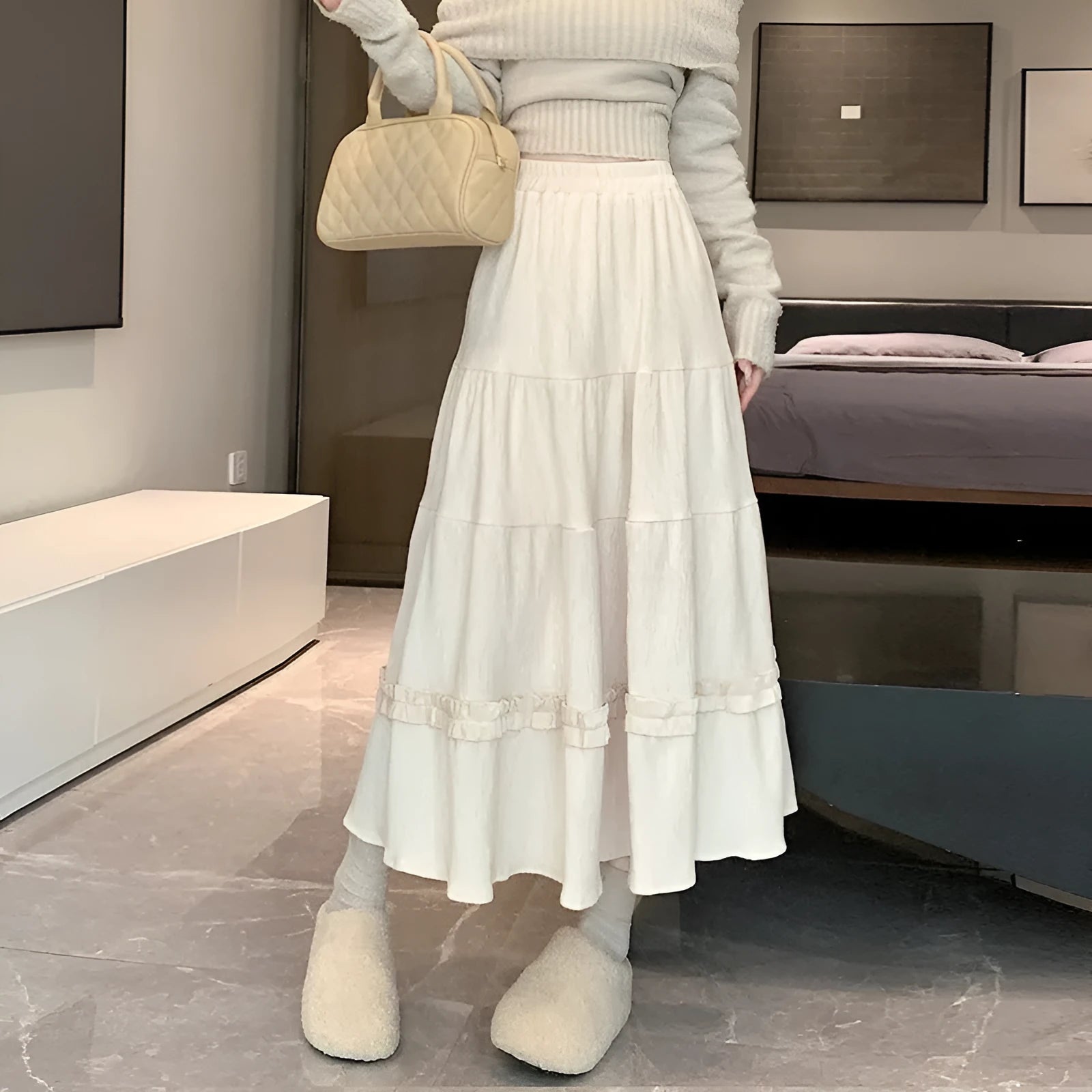 Korean-style solid colour corduroy A-line midi skirt with an elastic waistband.