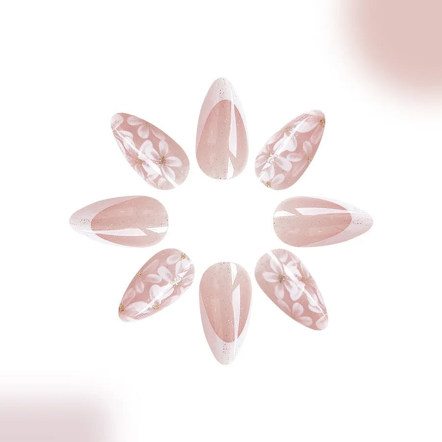 Short glossy almond French artificial nails with glittering powder flower decoration