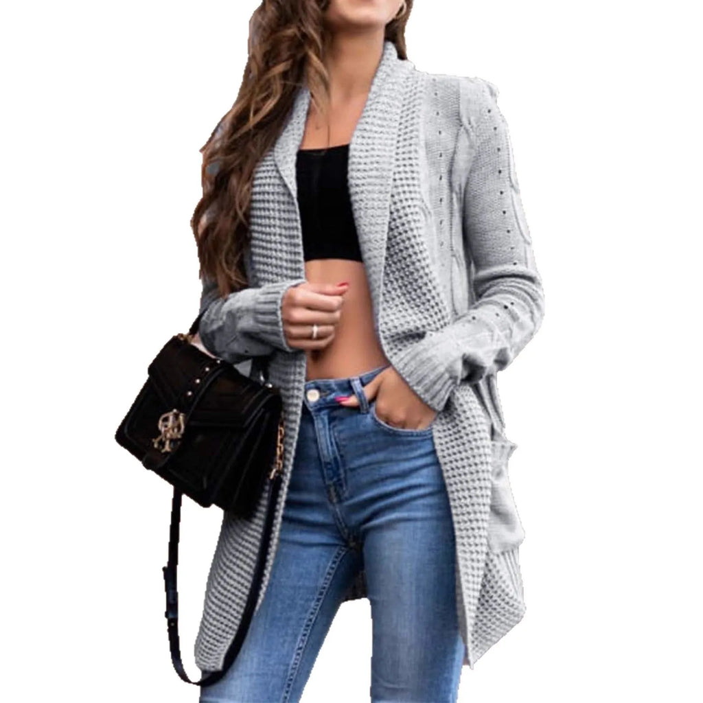 Grey loose-fit women's cardigan coat with pockets, shown in a street fashion style.