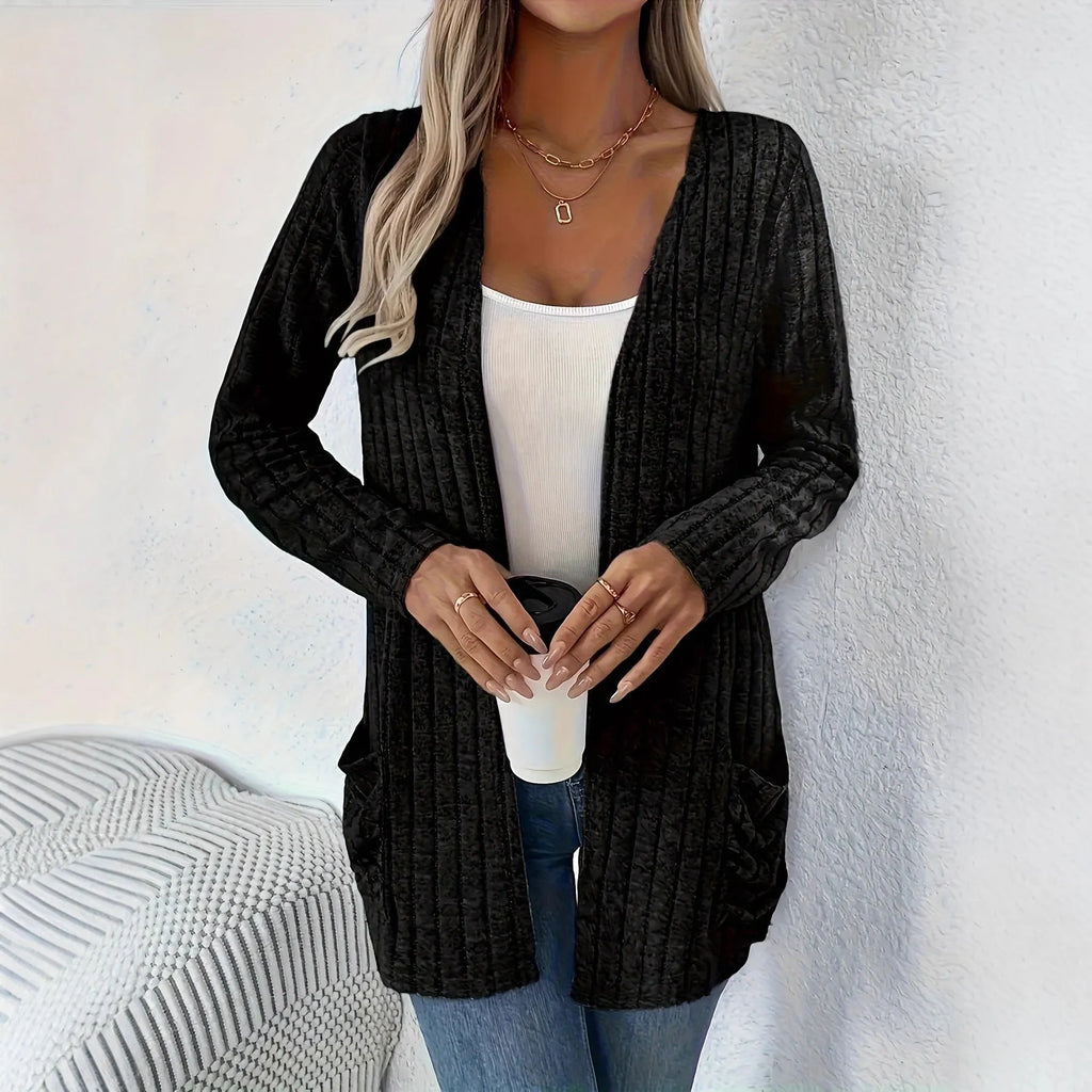 A woman's loose-fit long sleeve cardigan in Grandad Grey with pockets, shown on a hanger.
