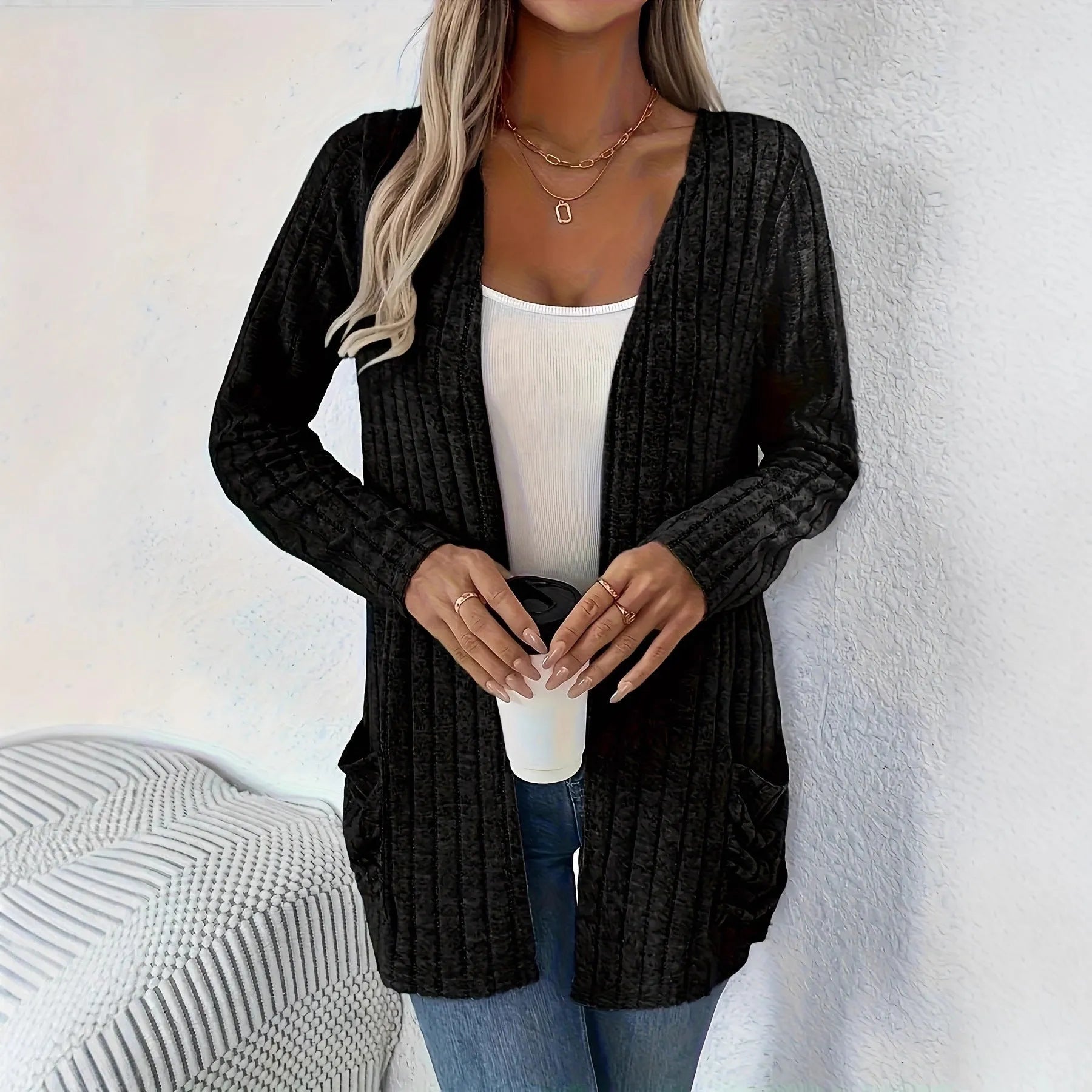 A woman's loose-fit long sleeve cardigan in Grandad Grey with pockets, shown on a hanger.