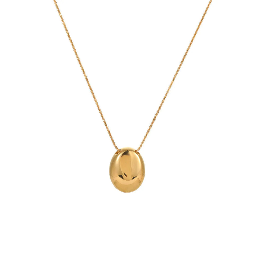 Gold geometric pendant necklace with adjustable chain on white background