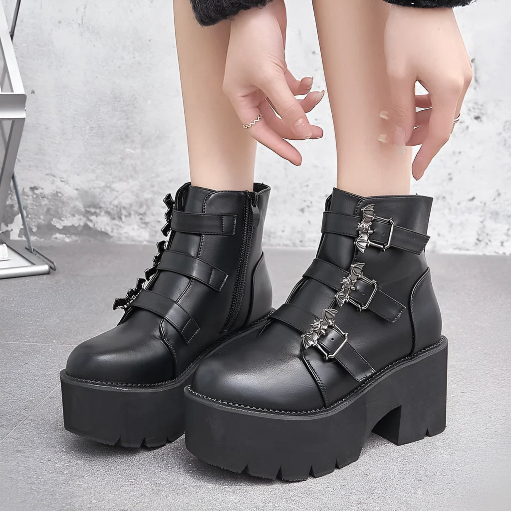Black women's punk style Martin boots with bat buckle and side zip closure