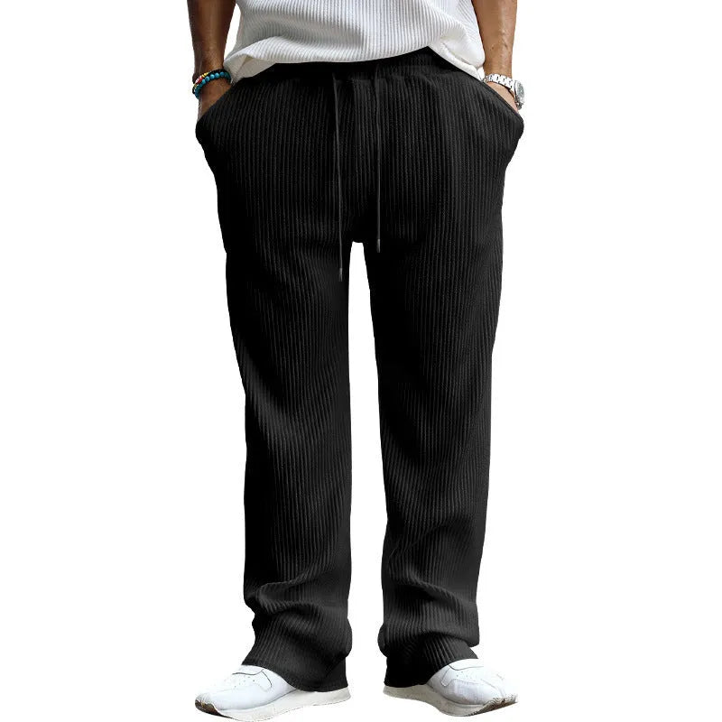Man wearing loose-fit high-waisted straight-leg casual trousers in khaki colour.