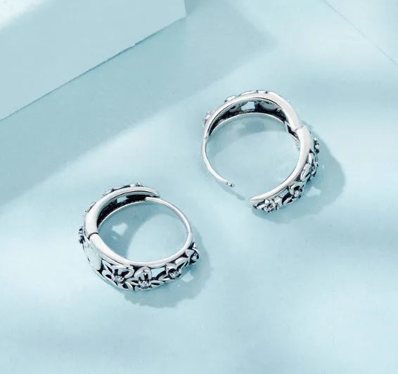 Close-up of women's retro hollow butterfly earrings made from S925 sterling silver with zircon stones.