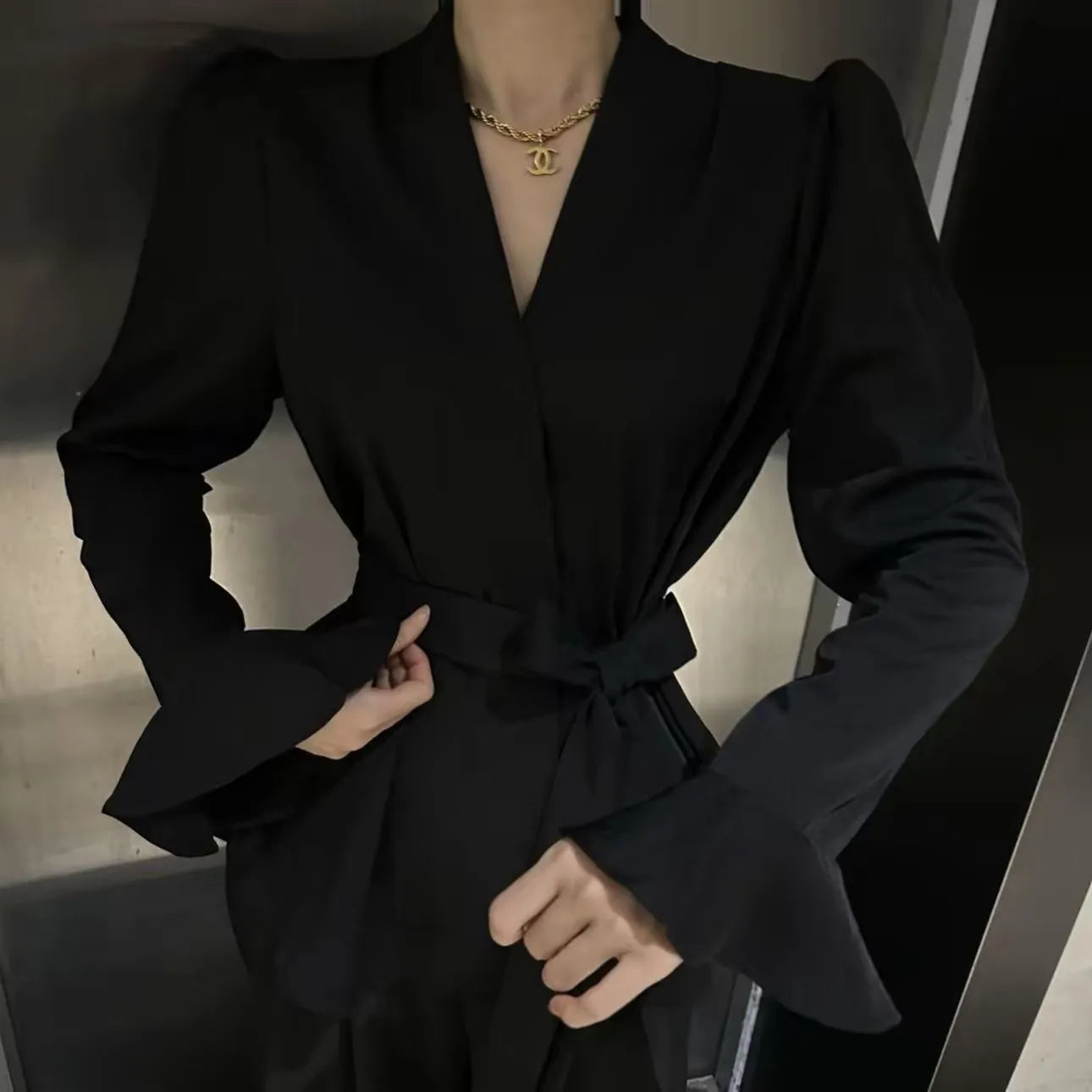 Women's French-style black shirt with irregular collar and long bell sleeves