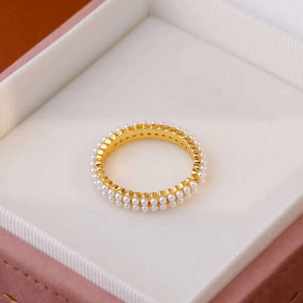 Gold geometry ring with open mouth design and round elements on copper