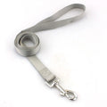 Solid colour polyester dog lead held in a hand, showing one of eleven colour options and its single rope construction.