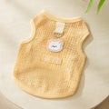 Green knitted cat clothing with bear patch design showing hollowed-out breathable fabric construction